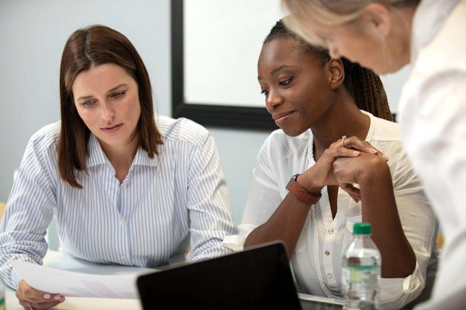 Business owner reviewing cash flow statements and financial documents during omeralentis learning program session
